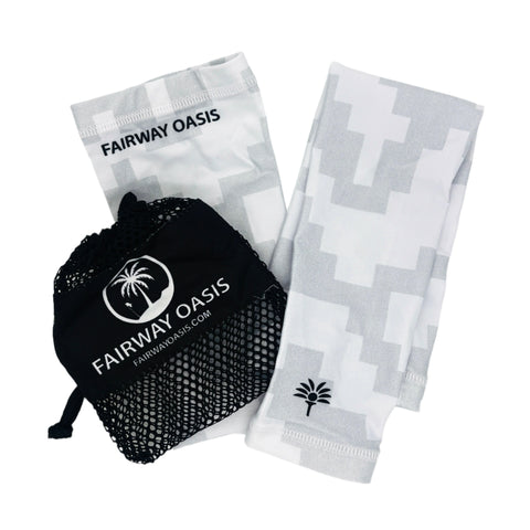 white and grey camo pattern arm sleeves with 'Fairway Oasis' branding and a black mesh bag on a white background