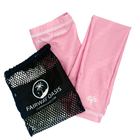Pink arm sleeves with a black travel mesh bag featuring 'Fairway Oasis' logo on a white background
